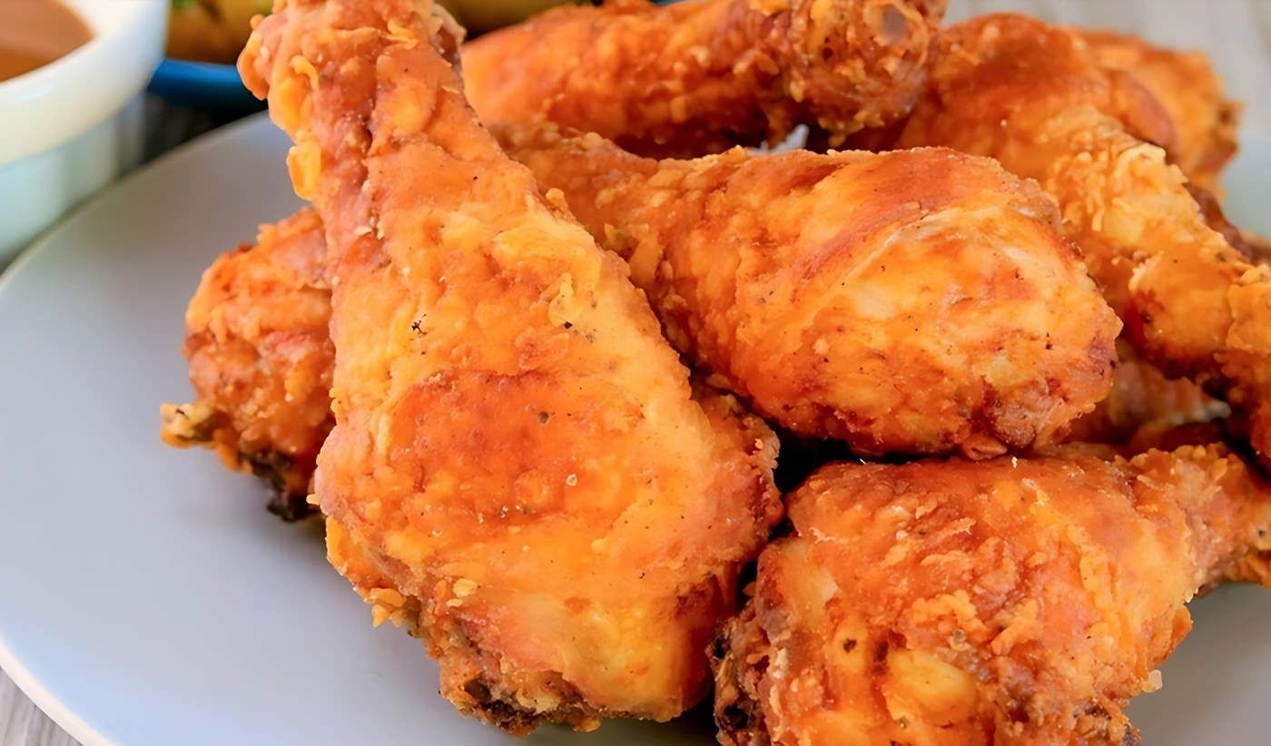 Plate of crispy golden fried chicken drumsticks
