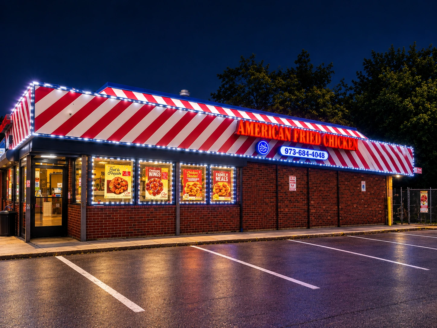 American Fried Chicken storefront lit up at night